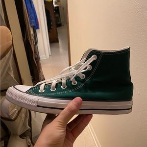 Dark green converse hi top.
